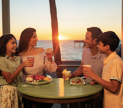 family dining out together at a beachfront restaurant in florida